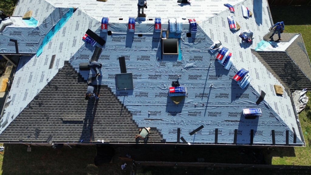 Aerial view of Roofing Redefined’s team expertly installing a new roof on a home