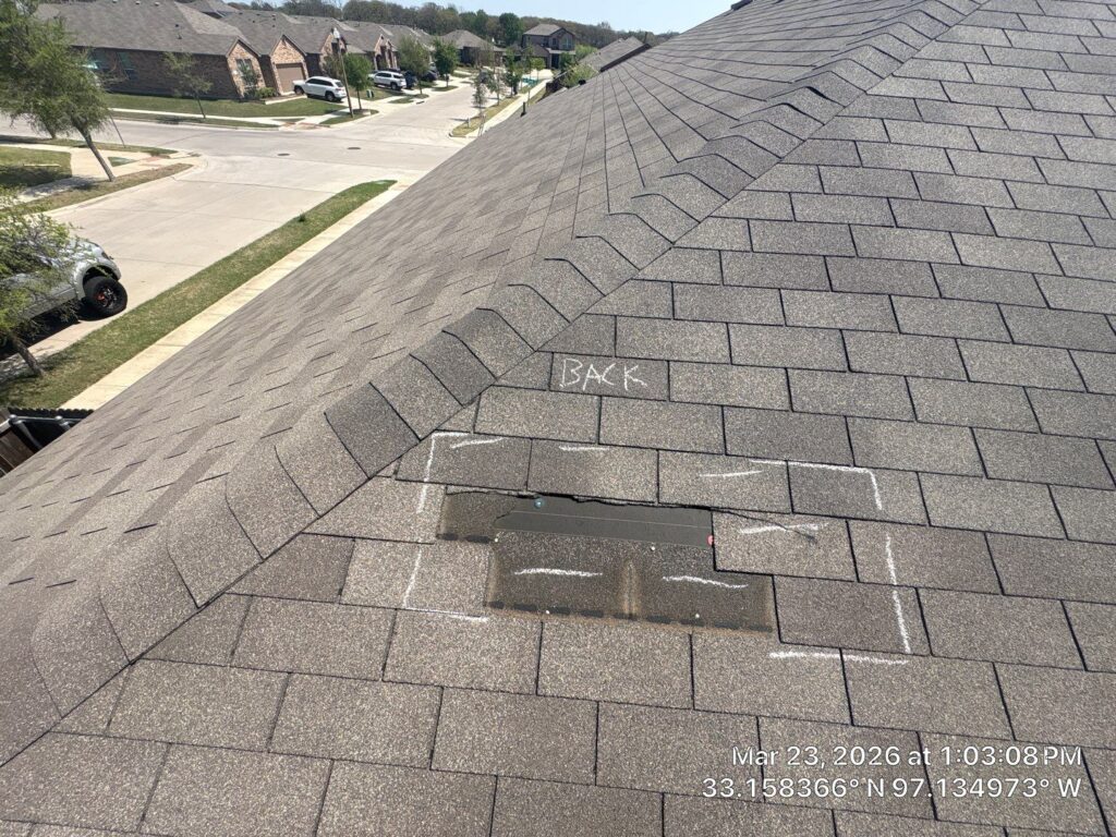 Roof inspection in Dallas-Fort Worth showing chalk markings on damaged residential shingles.