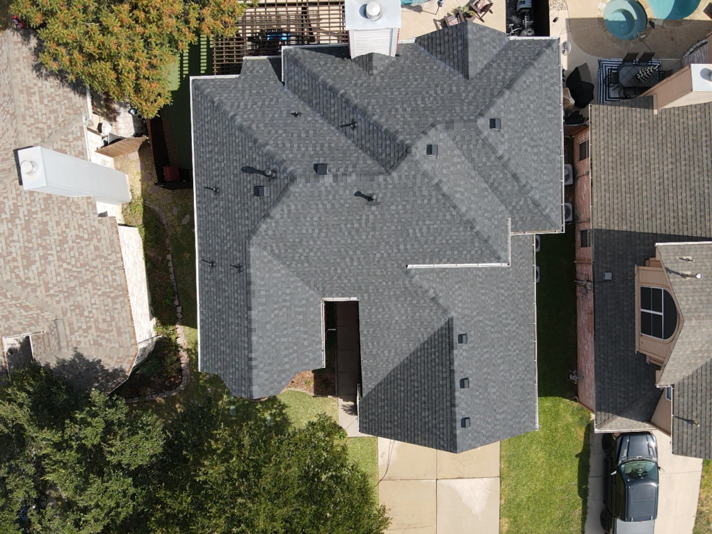 Aerial view of a completed residential shingle roof installation by Roofing Redefined in Dallas-Fort Worth.