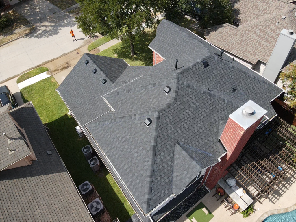 Aerial view of a completed residential asphalt shingle roof replacement by Roofing Redefined.