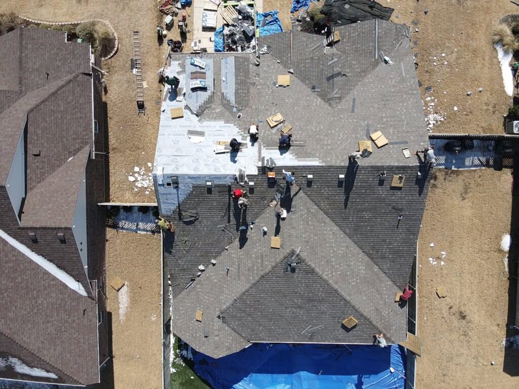 Aerial view of Roofing Redefined crew performing a complete residential roof replacement in Dallas-Fort Worth.
