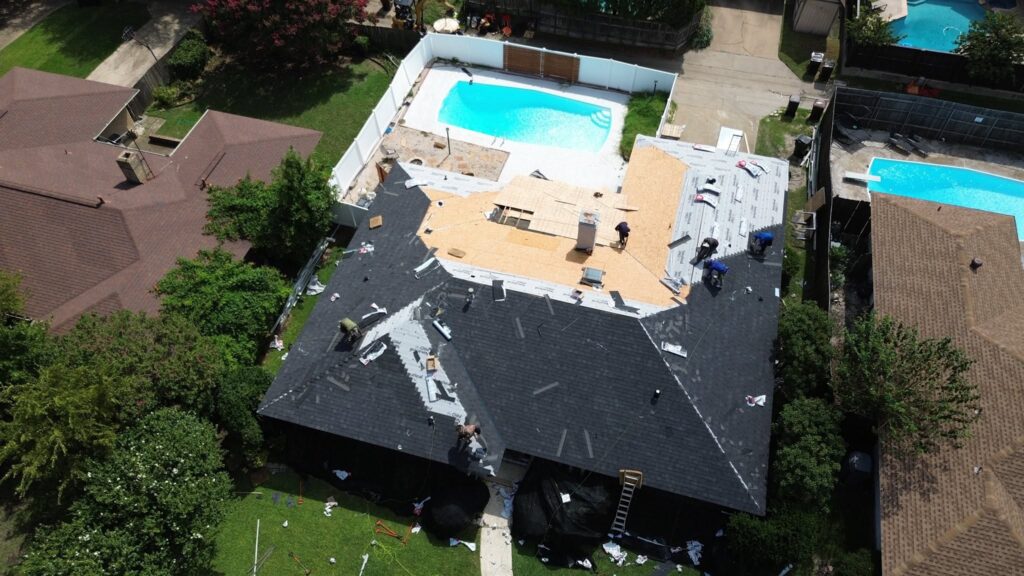 Aerial view of a roofing project in progress, showcasing Roofing Redefined's craftsmanship on a home