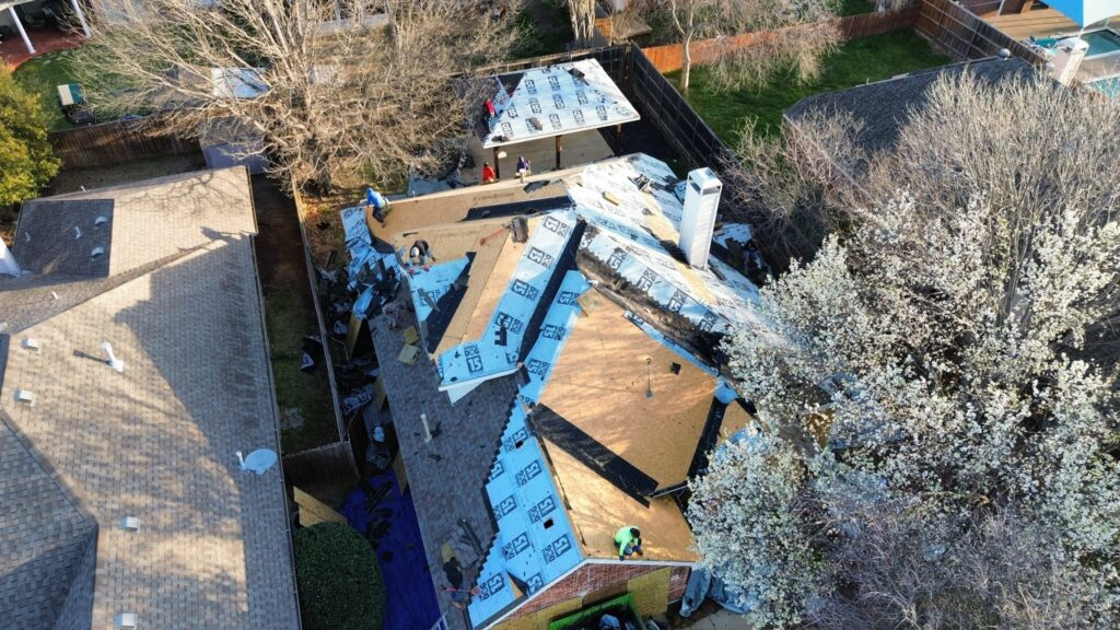 Aerial view of residential roof replacement project in progress by Roofing Redefined in Dallas-Fort Worth.
