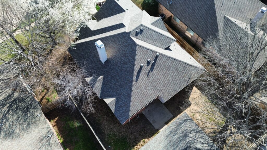 Aerial view of a completed shingle roof replacement by Roofing Redefined in Dallas-Fort Worth.