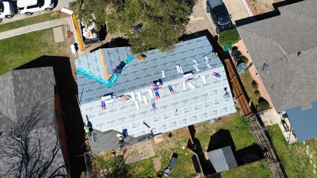 Aerial view of a roofing project in progress, showcasing Roofing Redefined’s craftsmanship in the Dallas-Fort