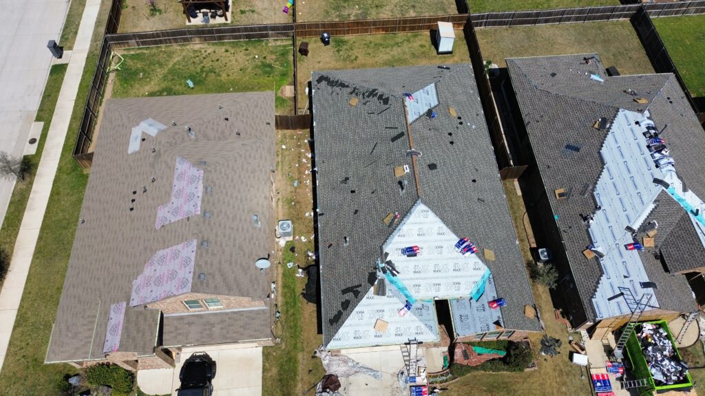 Aerial view showcasing roofing work in progress on a home in the Dallas-Fort Worth Metroplex